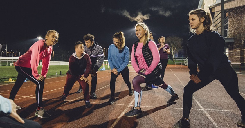Athletes stretching on a track